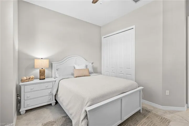 Bedroom with a closet, baseboards, and ceiling fan