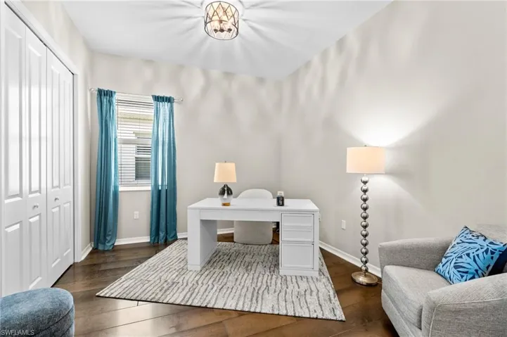 Home office with baseboards and dark wood finished floors