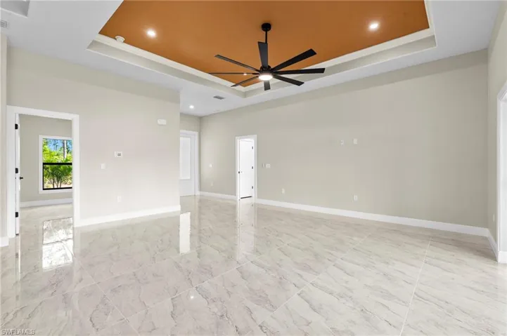 Open Floor Plan Living room showing guest room, to the right is the lanai and behind is the kitchen.