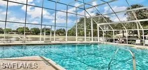 Community pool featuring screened lanai, sundeck, clubhouse with kitchen and indoor and outdoor bath