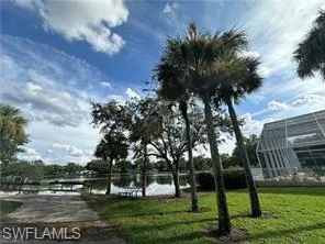 View of community with a boat ramp, a water view, and a boat dock