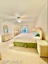 Primary Bedroom Suite with ceiling fan and light colored carpet