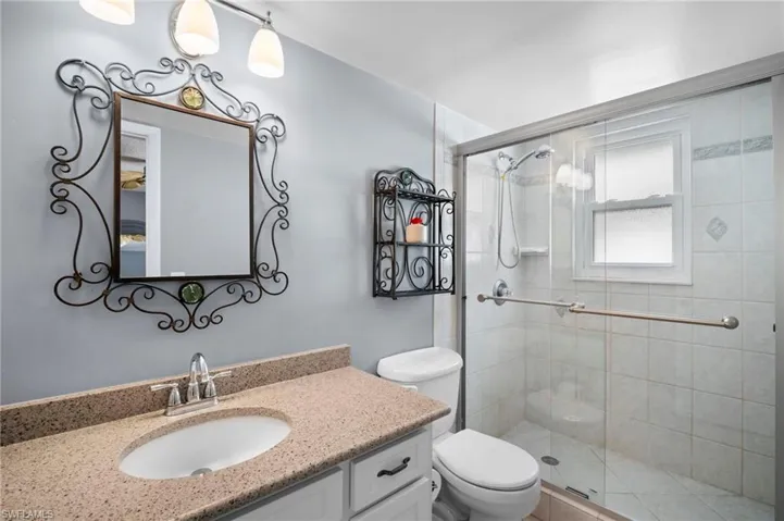 Full bathroom featuring vanity and a stall shower