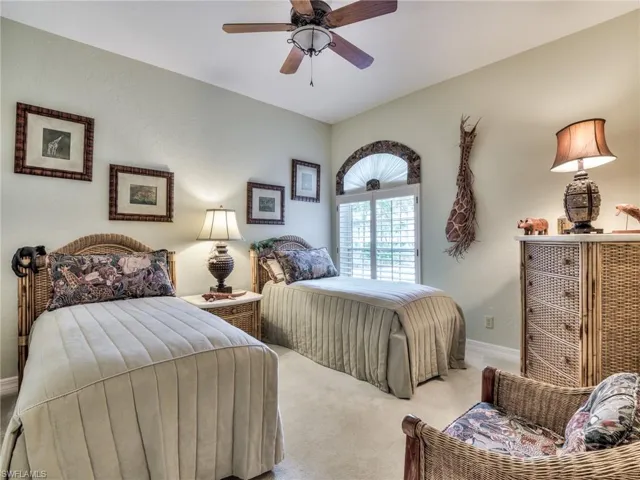 Carpeted bedroom with ceiling fan