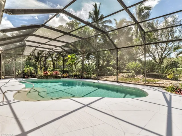 View of swimming pool with a lanai and a patio area