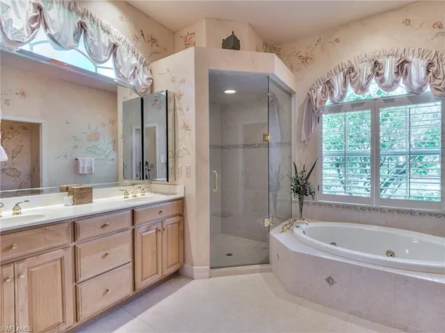 Bathroom with tile patterned floors, independent shower and bath, and vanity