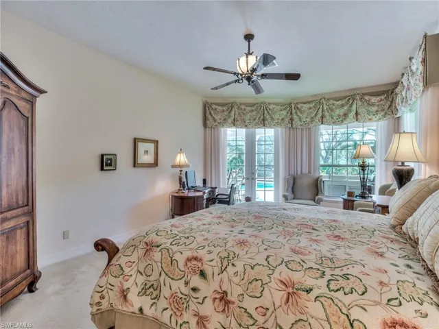 Carpeted bedroom with access to outside and ceiling fan