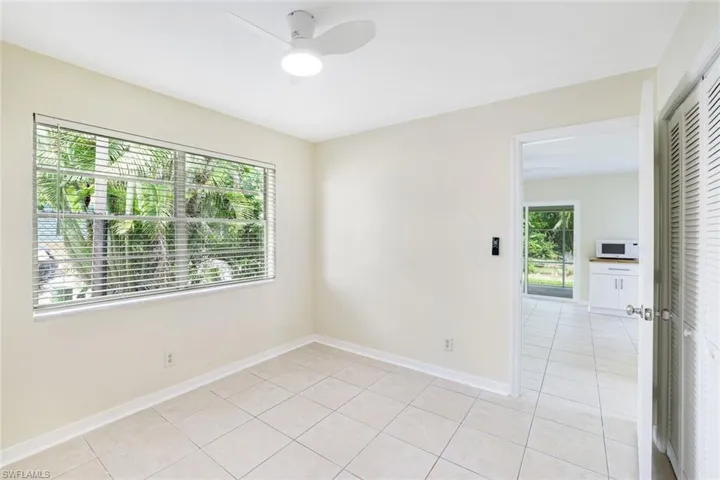 Empty room featuring light tile patterned floors and ceiling fan