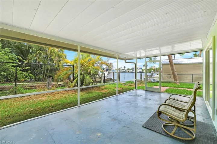 Unfurnished sunroom featuring a water view