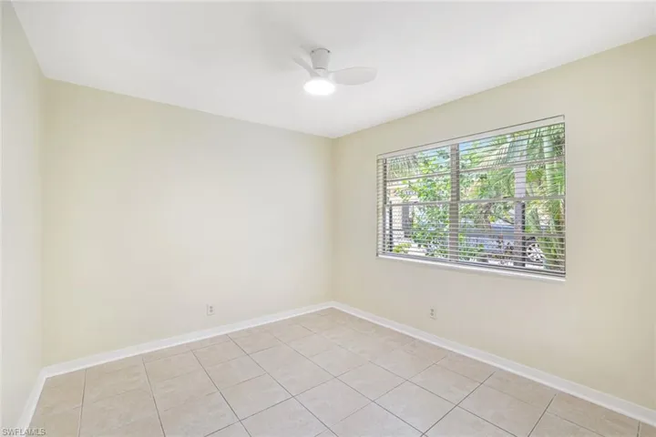 Spare room featuring a ceiling fan and light tile patterned floors