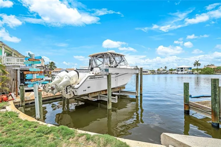 Dock featuring boat lift and a water view