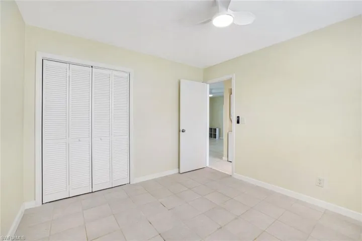 Unfurnished bedroom with a closet and a ceiling fan