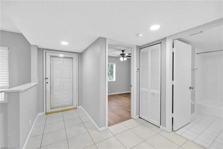Foyer featuring light tile patterned floors, ceiling fan, recessed lighting, and a textured ceiling