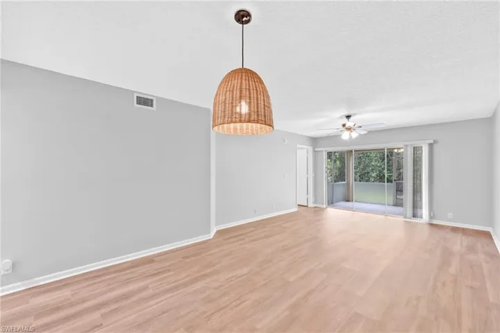 Empty room with light wood-style floors, a textured ceiling, and ceiling fan