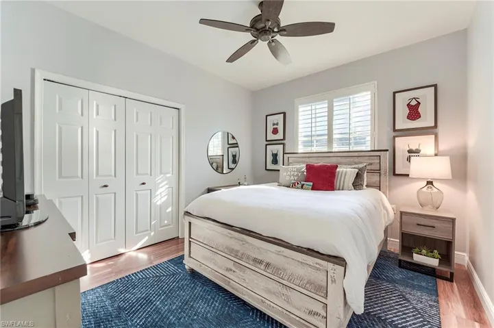 Bedroom featuring light wood-style flooring, ceiling fan, and a closet