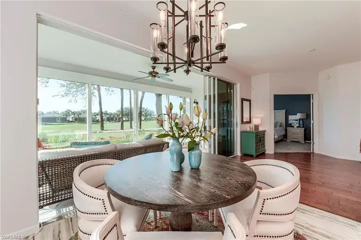Dining area featuring a chandelier, light wood-style flooring, and ceiling fan