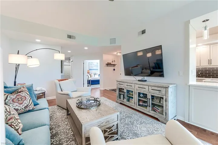 Living area featuring wood finished floors and recessed lighting