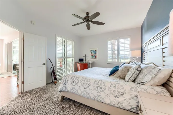 Bedroom featuring ceiling fan and carpet floors