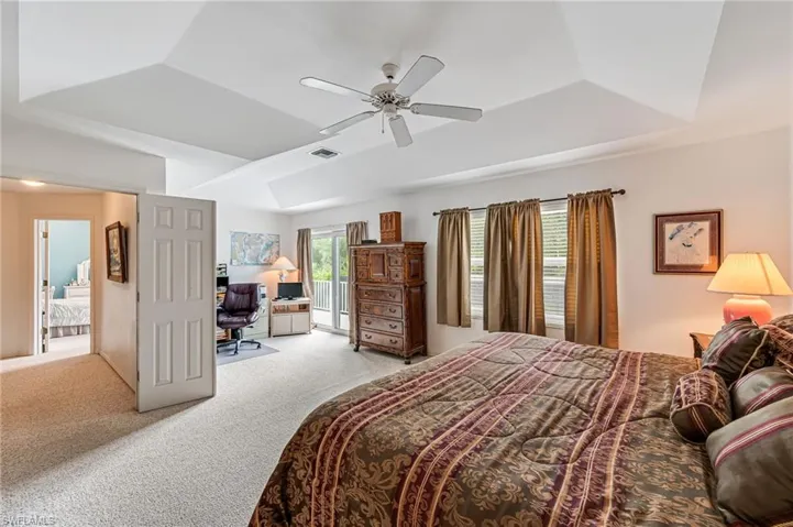 Sitting area in Primary with sliders out to balcony