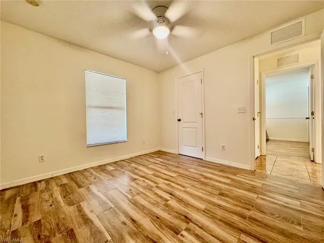 Spare room featuring ceiling fan and light hardwood / wood-style floors