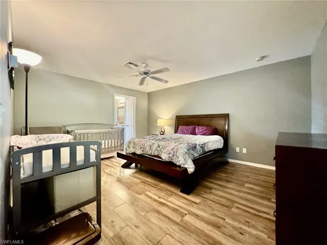 Bedroom with wood-type flooring and ceiling fan