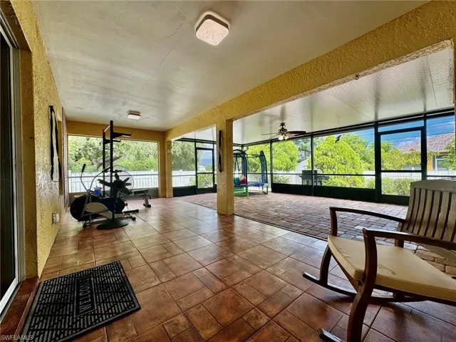 Unfurnished sunroom with ceiling fan