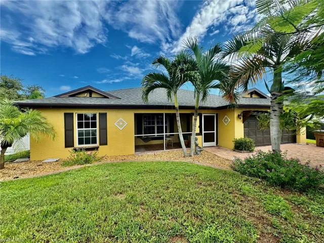 Ranch-style home featuring a front yard and a garage