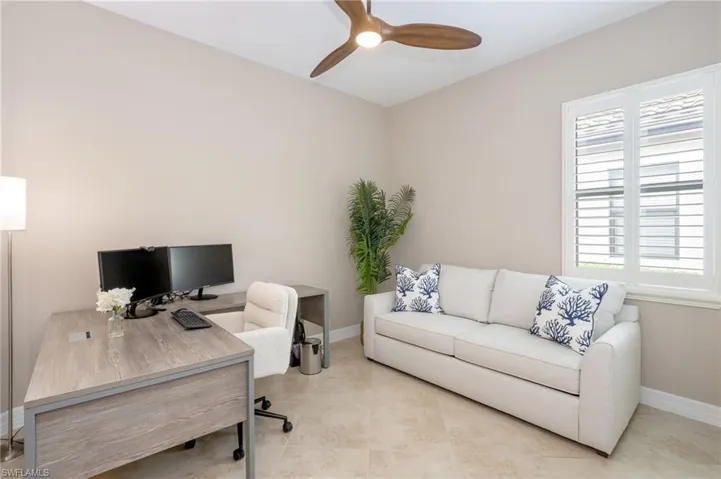 Tiled flooring, neutral wall tones, plantation shutters, and a ceiling fan with integrated lighting