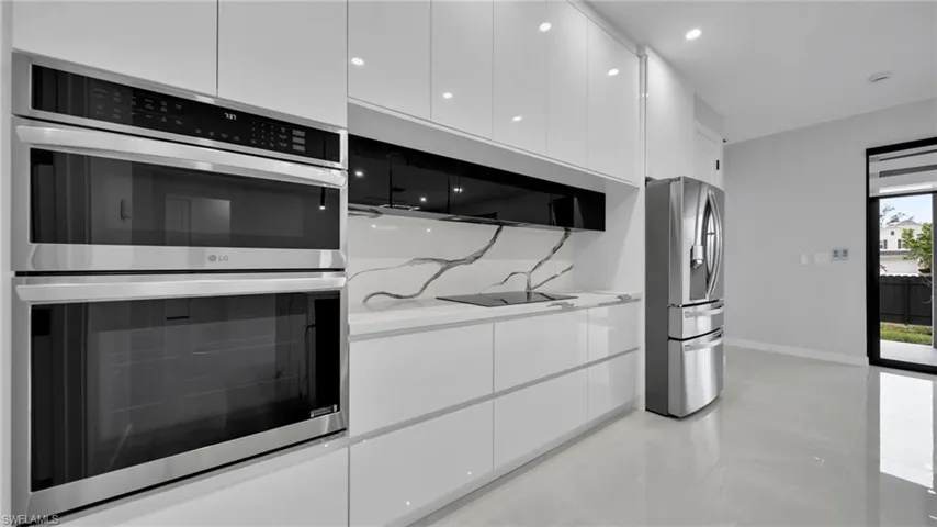 Kitchen featuring stainless steel appliances, white cabinetry, modern cabinets, recessed lighting, and finished concrete floors