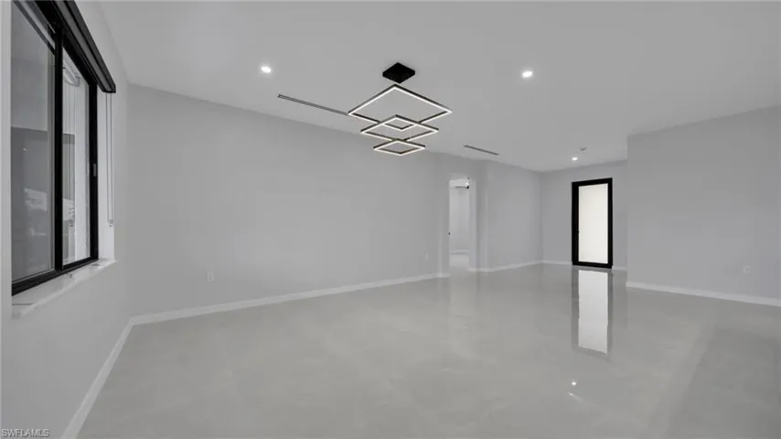 Unfurnished room with recessed lighting and finished concrete flooring