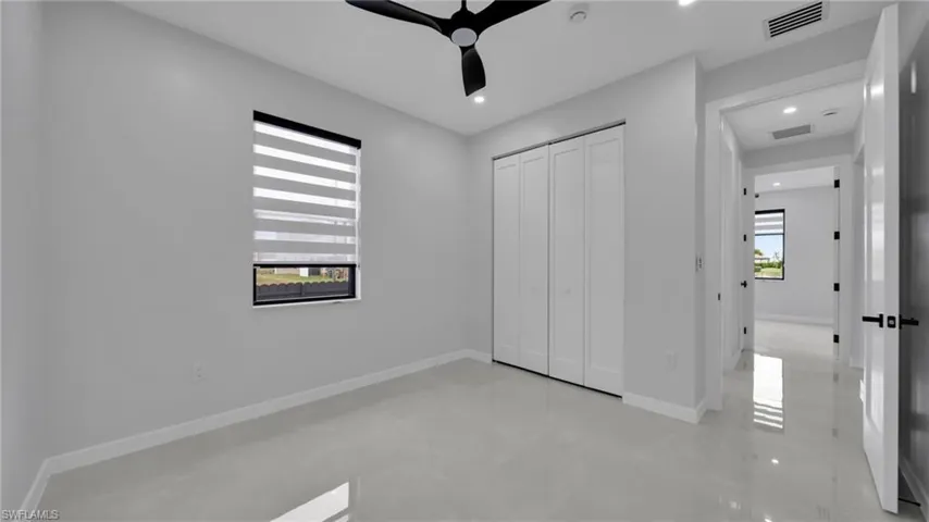 Unfurnished bedroom featuring a closet, ceiling fan, and recessed lighting