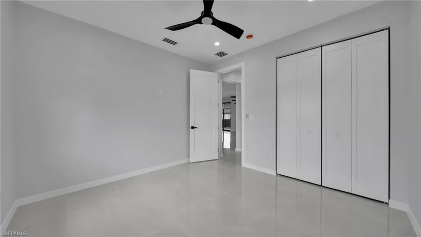 Unfurnished bedroom with a ceiling fan, a closet, and recessed lighting