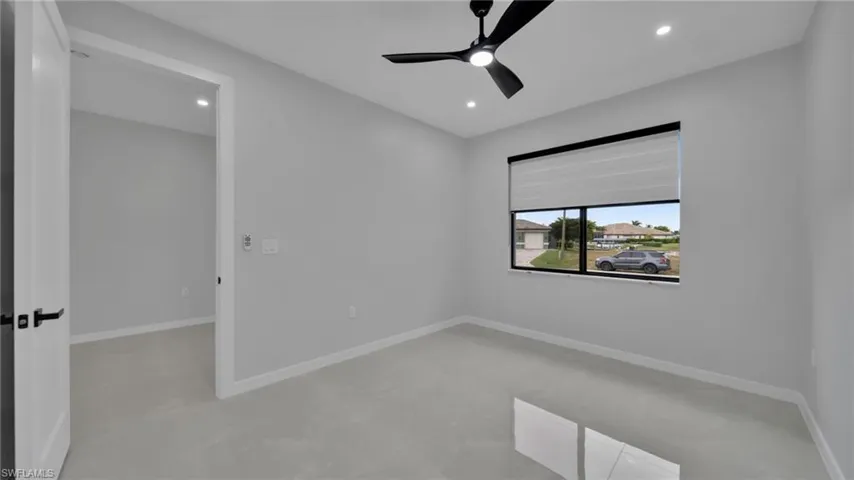 Empty room with recessed lighting, a ceiling fan, and concrete flooring