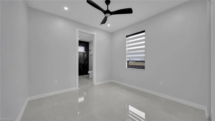 Unfurnished bedroom featuring a ceiling fan, finished concrete flooring, ensuite bath, and recessed lighting