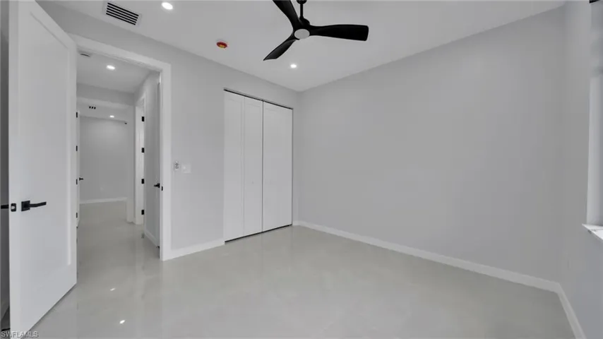 Unfurnished bedroom with a closet, recessed lighting, and a ceiling fan