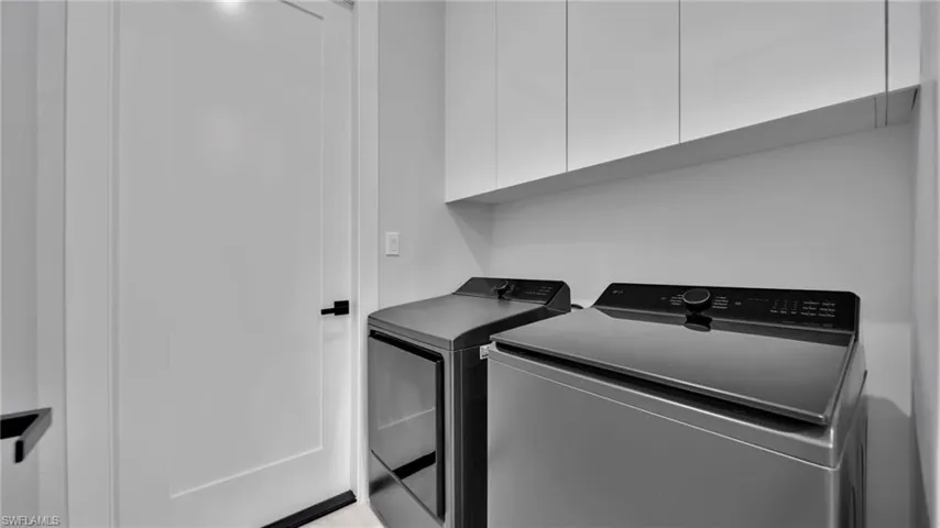 Laundry room featuring washer and dryer and cabinet space