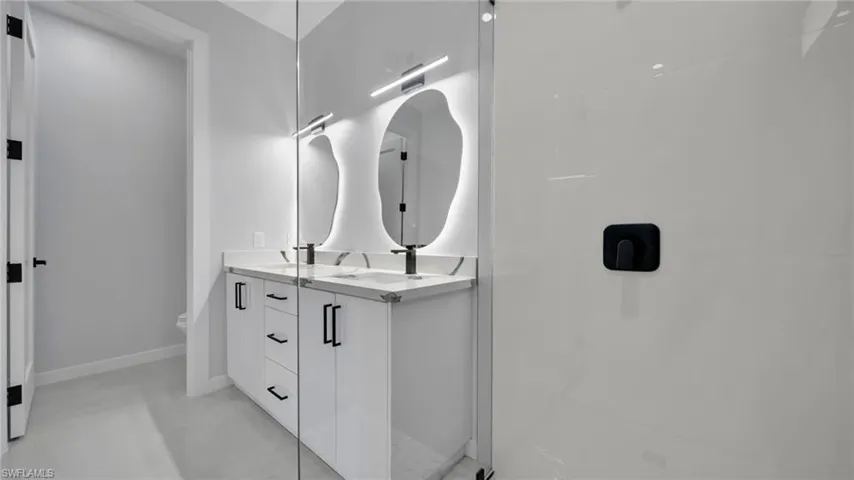 Bathroom with double vanity and walk in shower