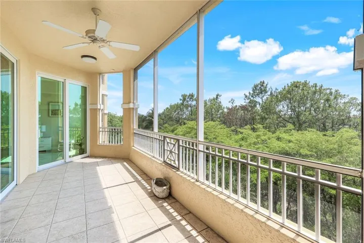 Unfurnished sunroom with a ceiling fan and tile patterned flooring