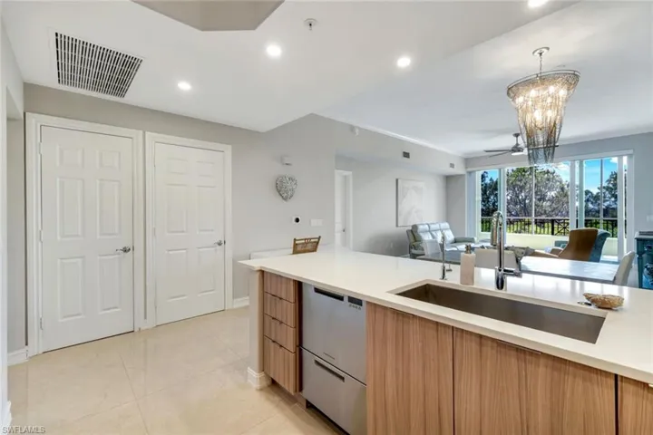 Kitchen with dishwasher, a sink, modern cabinets, open floor plan, and recessed lighting