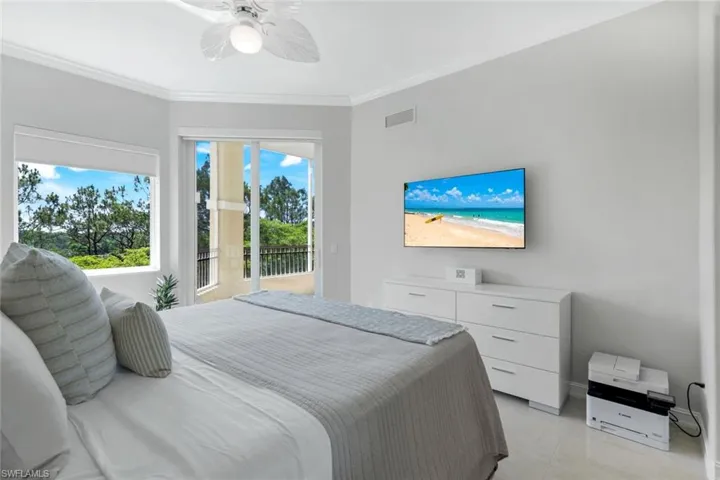 Bedroom with access to outside, crown molding, a ceiling fan, and light marble finish floors
