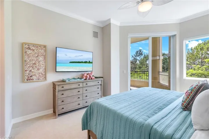 Bedroom featuring access to exterior, baseboards, multiple windows, crown molding, and a ceiling fan