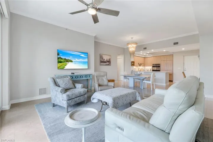 Living area with recessed lighting, a ceiling fan, ornamental molding, and baseboards
