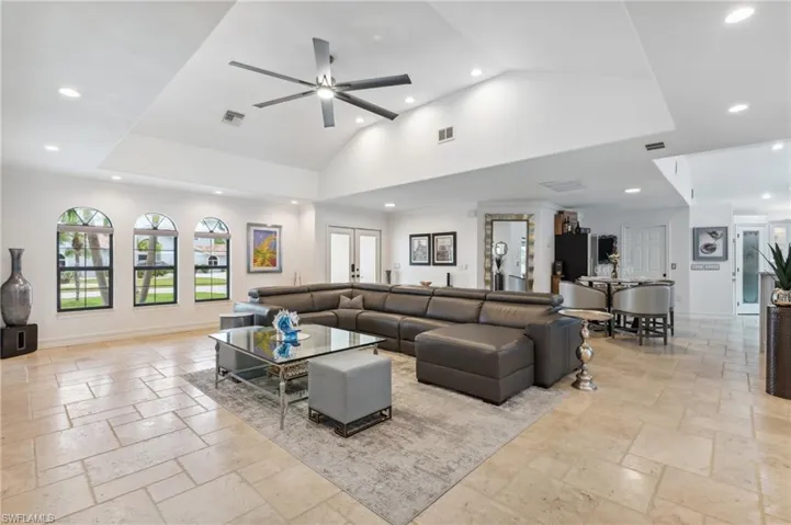 Living room with ceiling fan and french doors