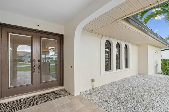 Property entrance featuring french doors