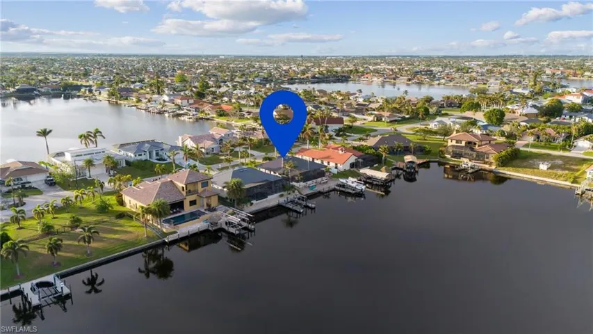 Birds eye view of property with a water view
