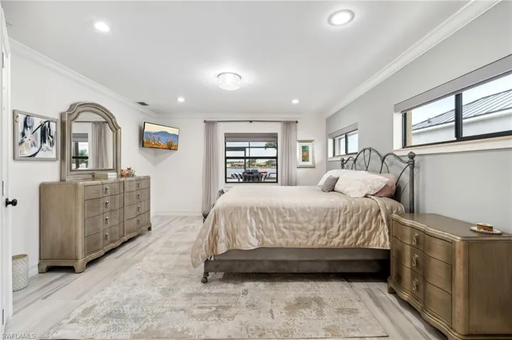 Bedroom featuring light hardwood / wood-style flooring and ornamental molding