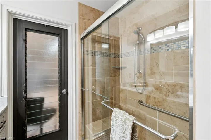 Bathroom featuring vanity and a shower with shower door