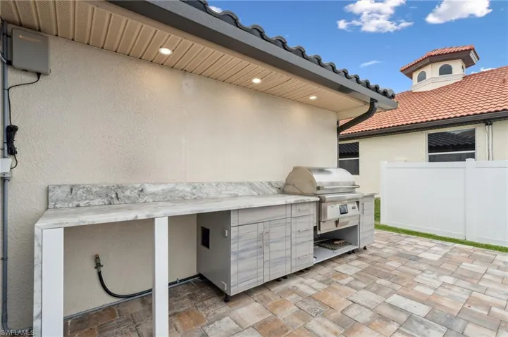 View of patio featuring area for grilling