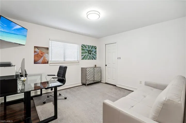 Home office with light colored carpet