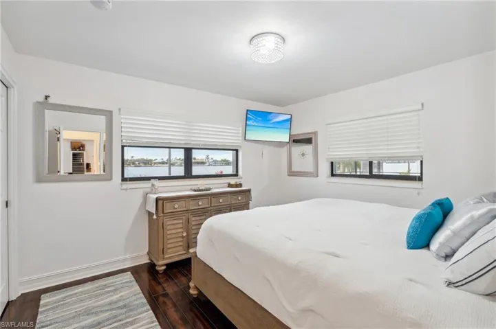 Bedroom with dark hardwood / wood-style floors